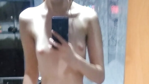 Pretty teen takes nude selfies showing her perky tits & her shaved pussy